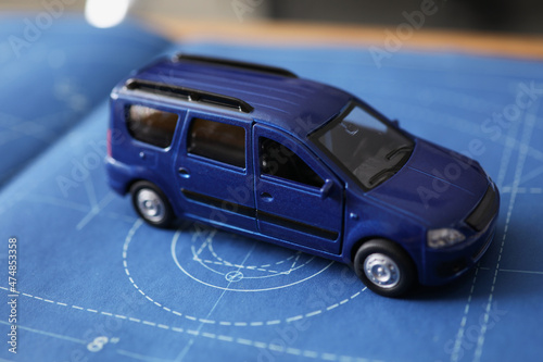 New car model development, miniature automobile model on blueprint paper