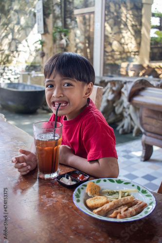a boy is having breakfast snacks