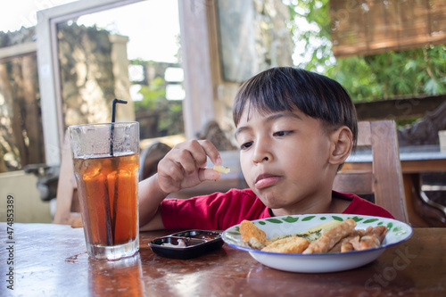 a boy is having breakfast snacks