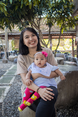 a mother and her baby daughter are hanging out