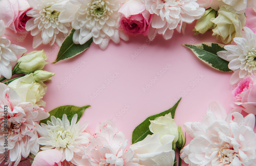 Frame made of flowers on pastel pink background. Frame made of flowers on pastel pink background.