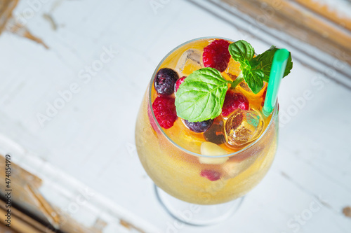 Cold and fresh white sangria with mint in wine glass 