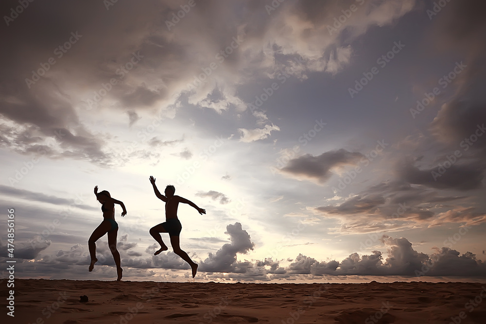 silhouettes of athletes running along the beach / sports summer in the warm sea, healthy rest, sports activity, summer vacation