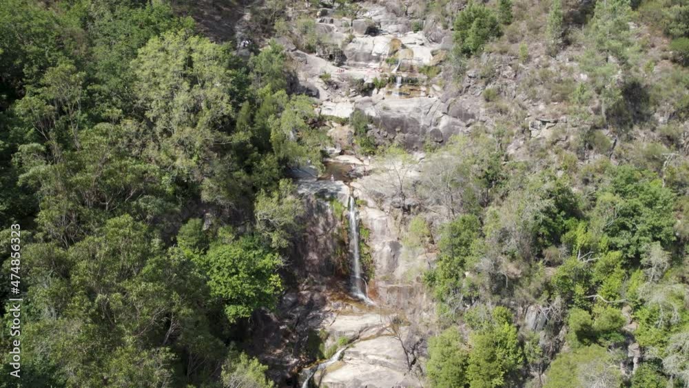 Aerial view over gerês national park, waterfall cascade, flowing down rock hill, Portugal Aerial view over gerês national park, waterfall cascade, flowing down rock hill, Portugal