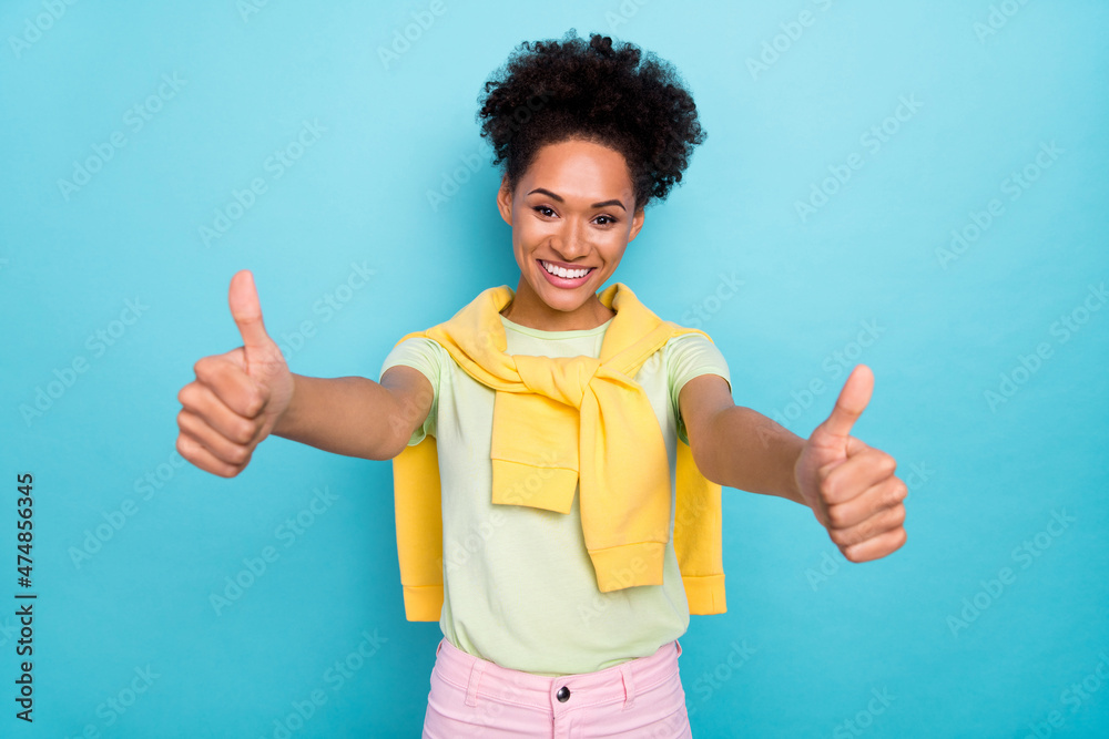 Photo of young pretty african girl good mood show thumbs-up advertise great select isolated over blue color background Photo of young pretty african girl good mood show thumbs-up advertise great select isolated over blue color background