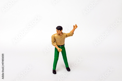 Miniature toy businessman figure holding something, white background.copy space.