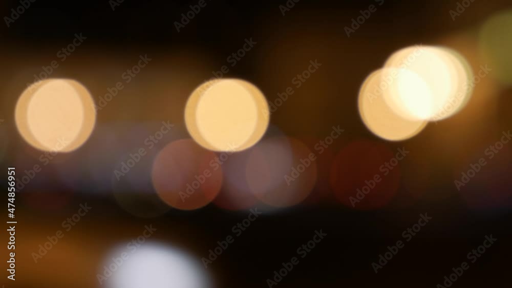 Beautiful glittering bokeh in dark blurry background at night. The round colorful bokeh shine from car lights on city street. Out of focus with blurry. Unfocused city lights. Traffic bokeh. Abstract Beautiful glittering bokeh in dark blurry background at night. The round colorful bokeh shine from car lights on city street. Out of focus with blurry. Unfocused city lights. Traffic bokeh. Abstract