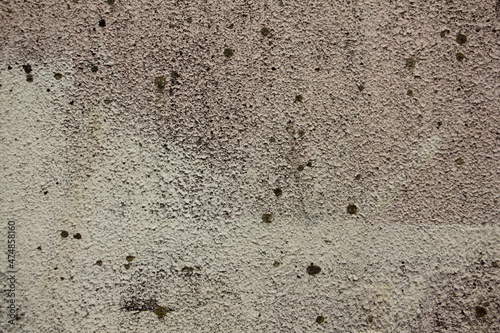 Rough gray dry plastered concrete wall with spots surface close up industrial background texture
