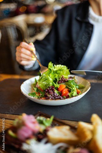 woman eating salad in the restaurant