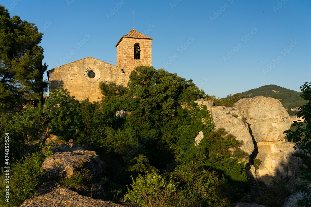 VIew of the medieval village of Siurana with its church at sunset.
