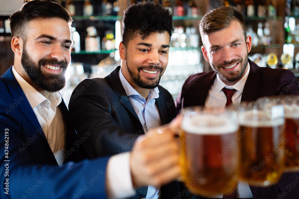 Cheerful old friends having fun and drinking beer at bar counter in pub. Cheerful old friends having fun and drinking beer at bar counter in pub.