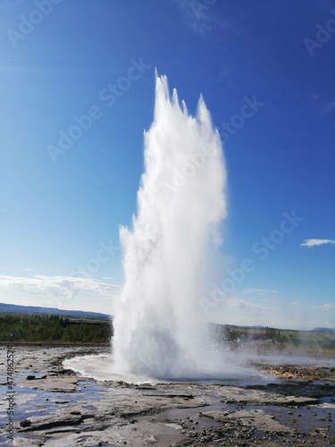 geyser expelling water on a blue background