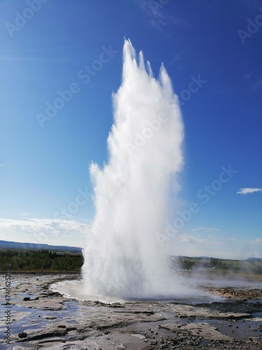 geyser expelling water on a blue background