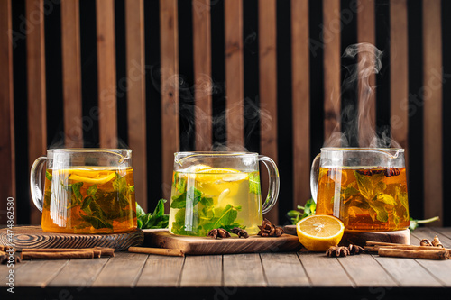Photography Side view on three glass pots of various hot tea
