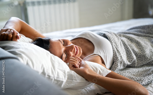 Young beautiful woman waking up fully rested in the morning