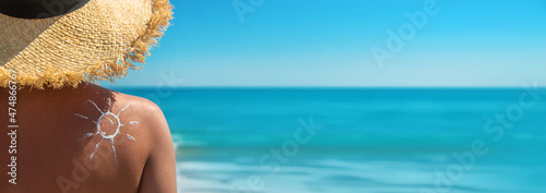 Fotografie Woman with sunscreen on her back. Selective focus.