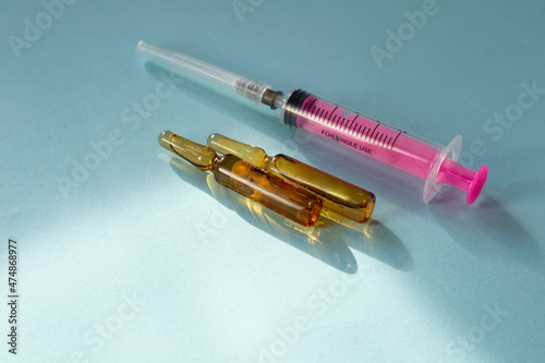 Wallpaper Mural Ampoule of medicine for injections and syringe. Injection  liquid and syringe on pink background  Torontodigital.ca