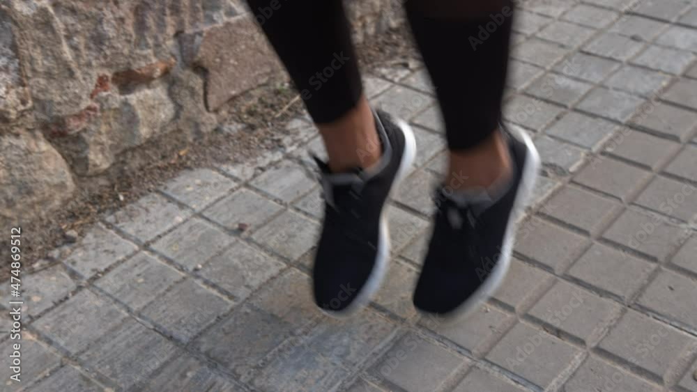 Beautiful fit woman exercising and jumping on street Beautiful fit woman exercising and jumping on street