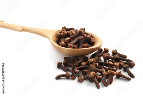 Wallpaper Mural Pile of aromatic dry cloves and wooden spoon on white background, closeup Torontodigital.ca