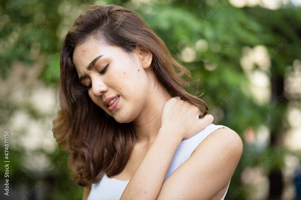 Asian woman having shoulder pain, office syndrome