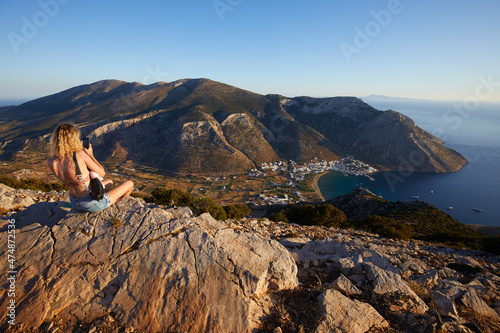 Young woman watching the panorama over Kamares Bay, Sifnos, Cyclades Islands, Greece