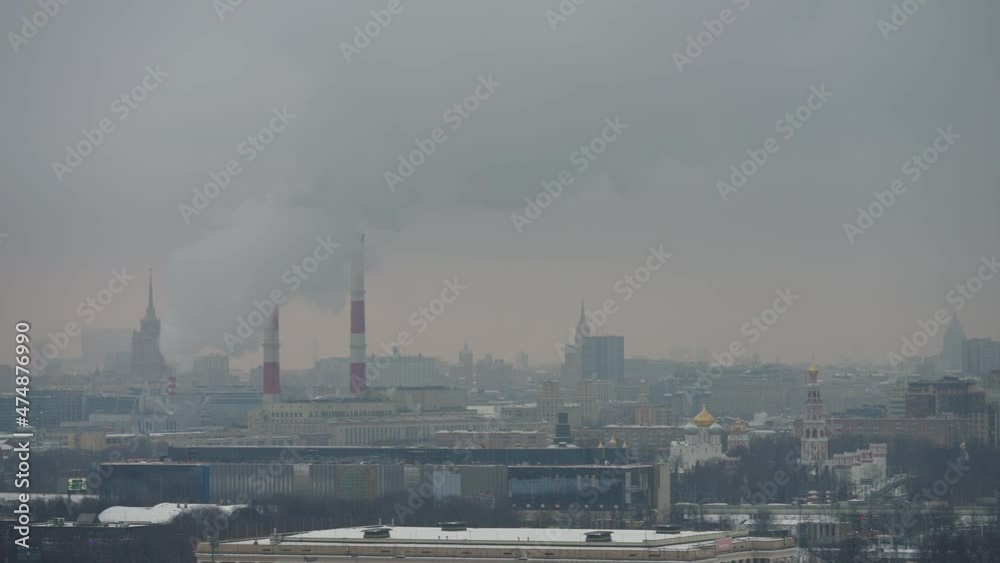 View of the winter landscape of the city of Moscow from the observation deck. An active winter city in fog View of the winter landscape of the city of Moscow from the observation deck. An active winter city in fog