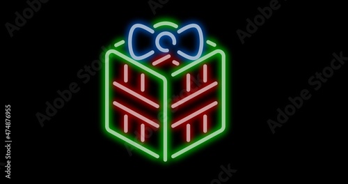 Digital composite of illuminated bow on christmas present with copy space over black background photo