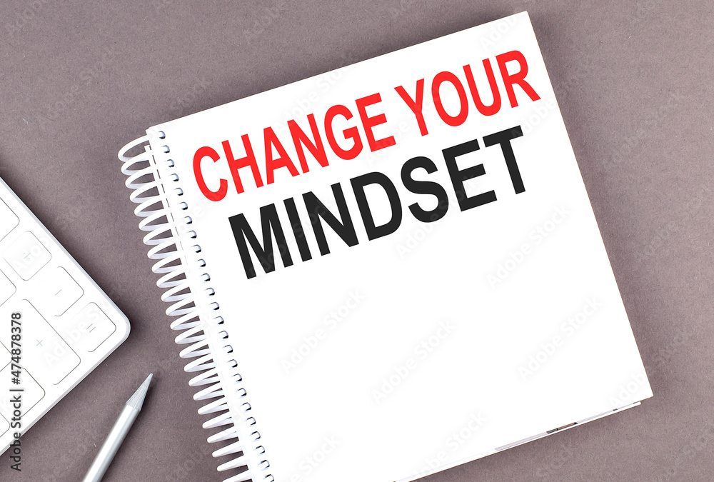 CHANGE YOUR MINDSET text on the notebook with calculator and pen CHANGE YOUR MINDSET text on the notebook with calculator and pen