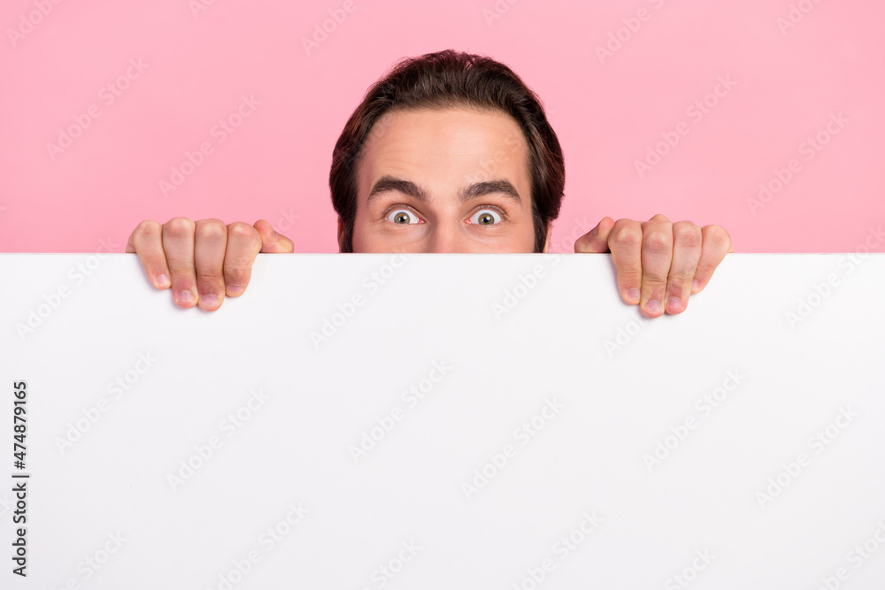 Photo of young guy amazed look from white wall advertising staring isolated over pink color background