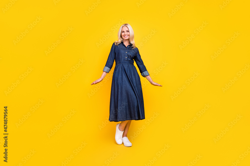 Photo of pretty sweet lady pensioner dressed denim outfit smiling walking isolated yellow color background