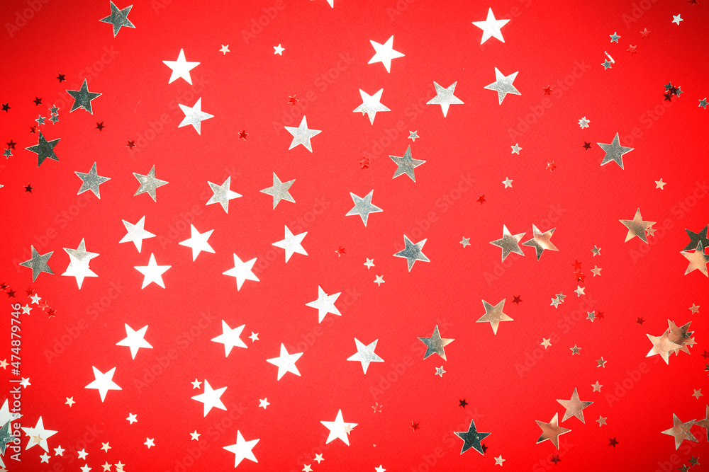 Sequins are scattered on a red background. Sequins are scattered on a red background.