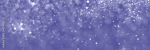 Trendy very peri color of the year 2022, violet blue sparkling glitter background, christmas texture. Abstract defocused header. Wide screen wallpaper. Panoramic web banner with copy space for design