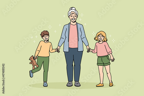 Happy grandmother active lifestyle concept. Smiling positive grandmother standing holding her grandchildren girl and boy with hands feeling cheerful vector illustration 