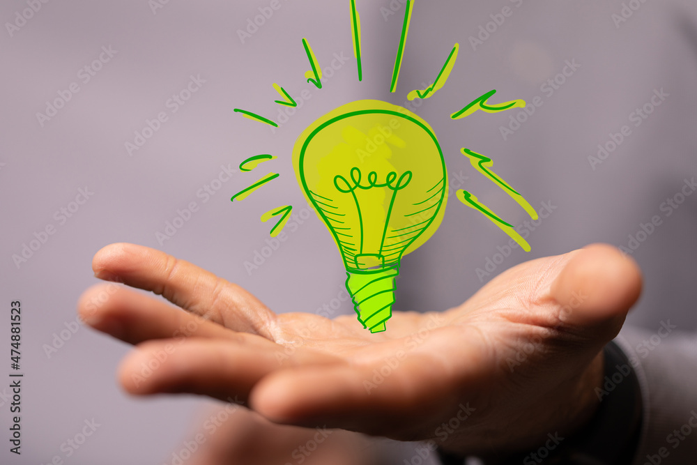 Hands holding green nature in the light bulb Hands holding green nature in the light bulb