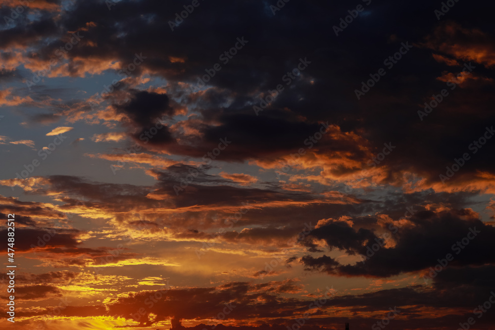 Gorgeous scenic of the sunrise or sunset with dark lining and cloud on the orange sky. Vibrant and Colorful background