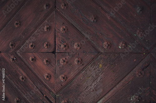 Medieval church door. Detail of the door of the Gothic church. background of old grunge, texture of medieval ornament. part of a vintage old door.