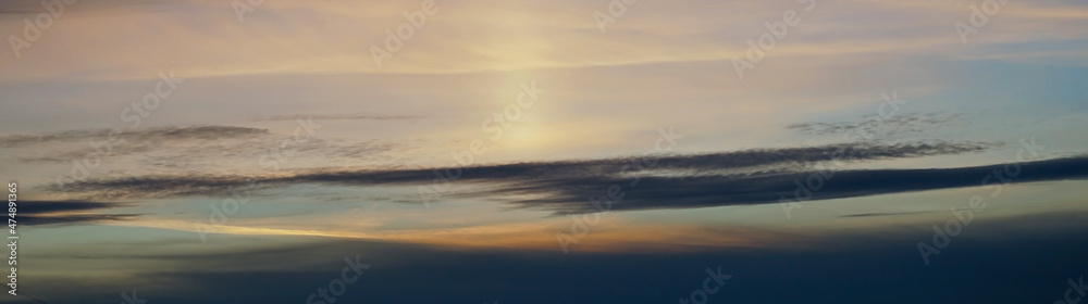 Pink orange yellow sunset. Beautiful evening sky with clouds. Skies background with copy space for design. Wide banner. Website header. Panoramic.