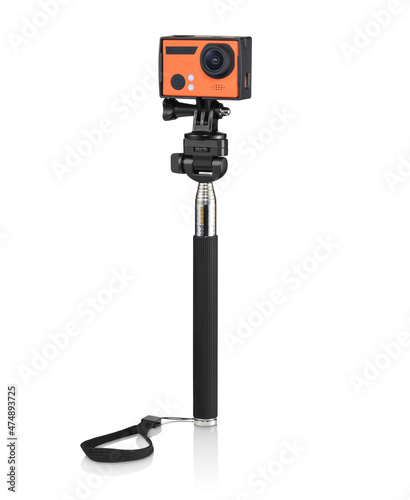 Modern orange action camera on a selfie stick, isolated 