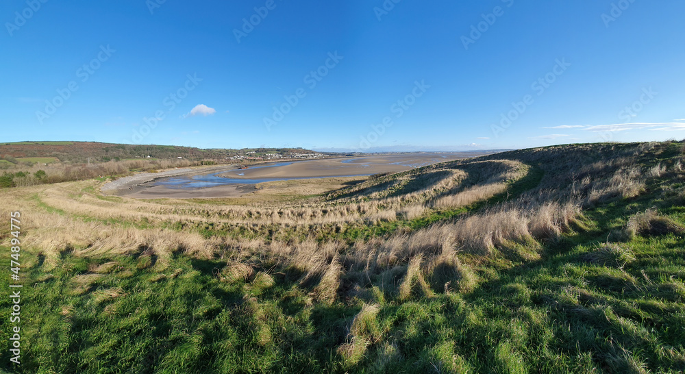 Panoramic coastline view of Teletubby Hill at Burry Port Carmarthenshire South Wales which is a popular tourist holiday travel destination and attraction landmark, stock photo image