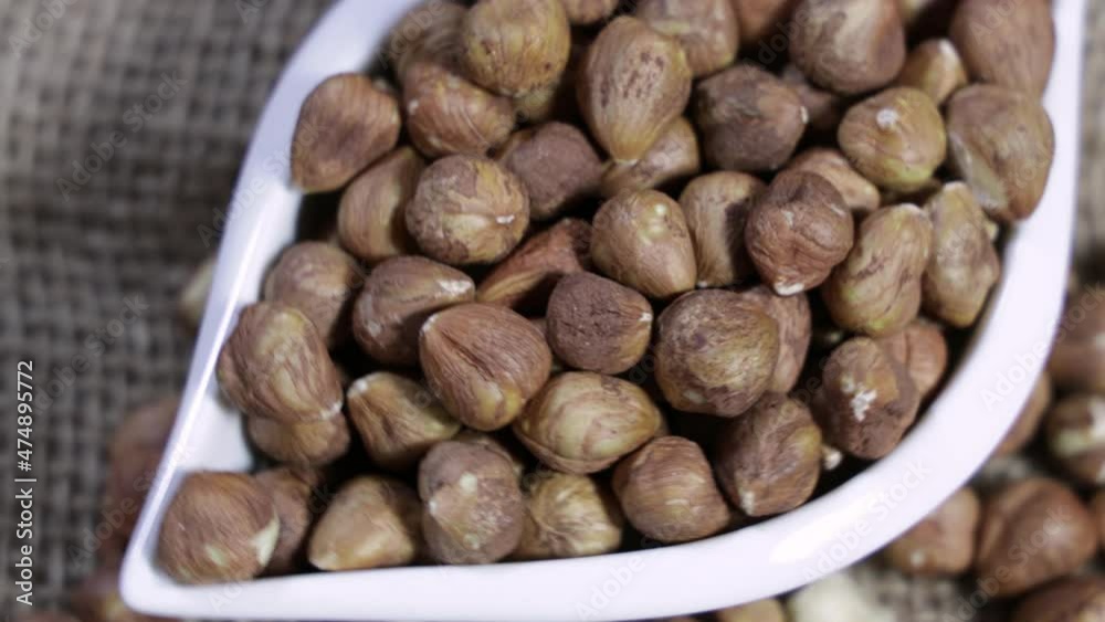 Close up peeled hazelnuts rotating. Healthy, dietary food. Close up peeled hazelnuts rotating. Healthy, dietary food.