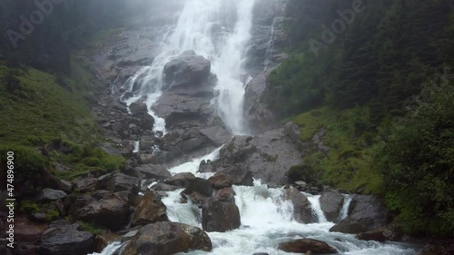 Tilt shot of the Grawa Waterfall on a cloudy rainy day in Stubai Valley Tyrol, Austria photo