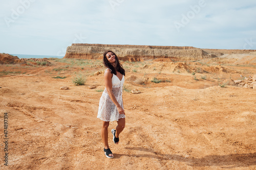 beautiful woman walking in the clay desert photo