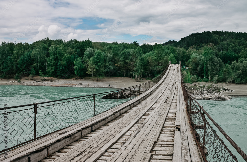 Wooden bridge over the mountain river