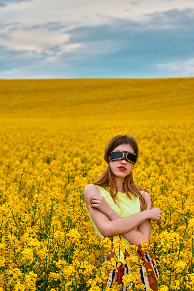 young girl in sunglasses in yellow rapeseed field. portrait young girl in sunglasses in yellow rapeseed field. portrait