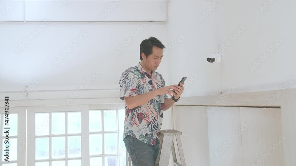 Asian Man On A Ladder Use Mobile Phone Control Security Cctv Camera
Asian Man On A Ladder Use Mobile Phone Control Security Cctv Camera