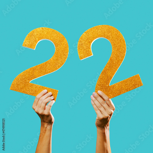 man shows the number 22 in his hands photo