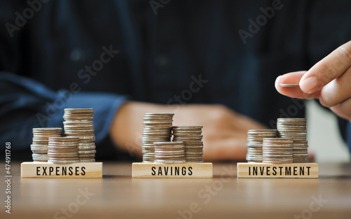 Businessmen or accountants are stacking coins to plan future financial account management. Income Management Concepts for Savings investment and expenses photo