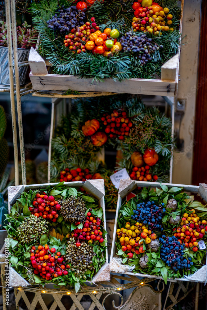 sale of original beautiful Christmas wreath of natural spruce needles and various fruits, berries and nuts on the eve of Christmas