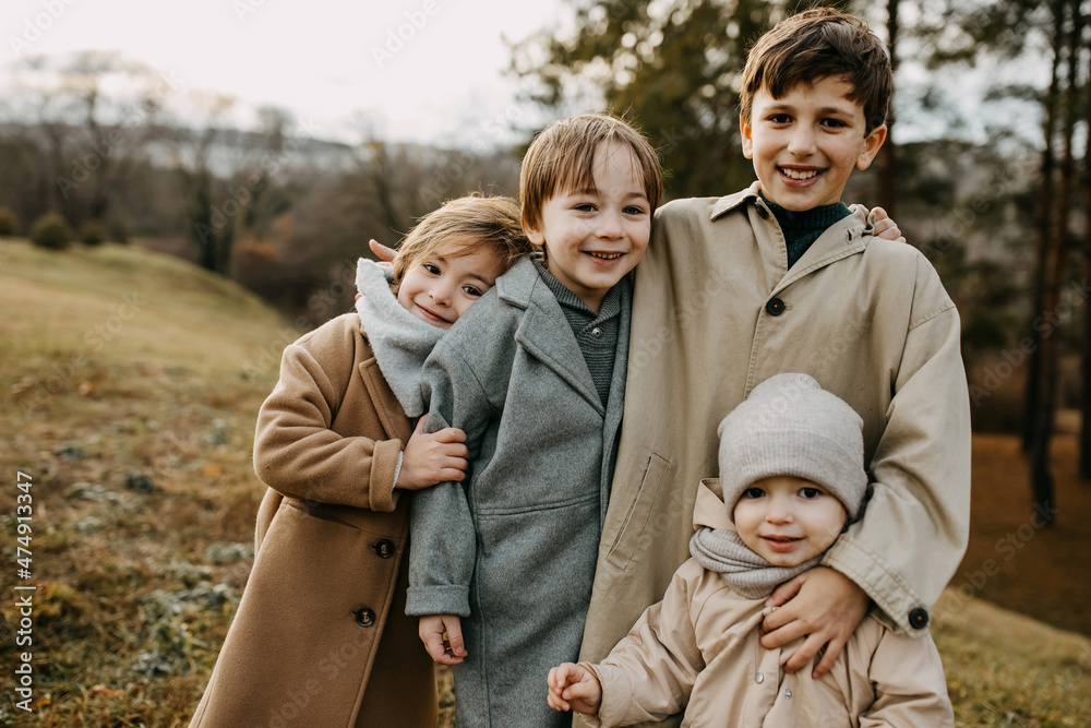 Friends hugging, smiling, spending time outdoors in a park on autumn day. Friends hugging, smiling, spending time outdoors in a park on autumn day.