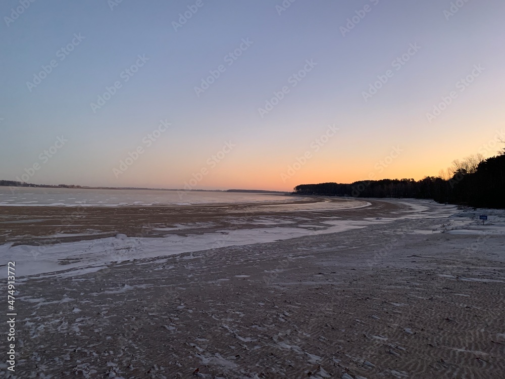 sunrise on the winter beach of the Volga river